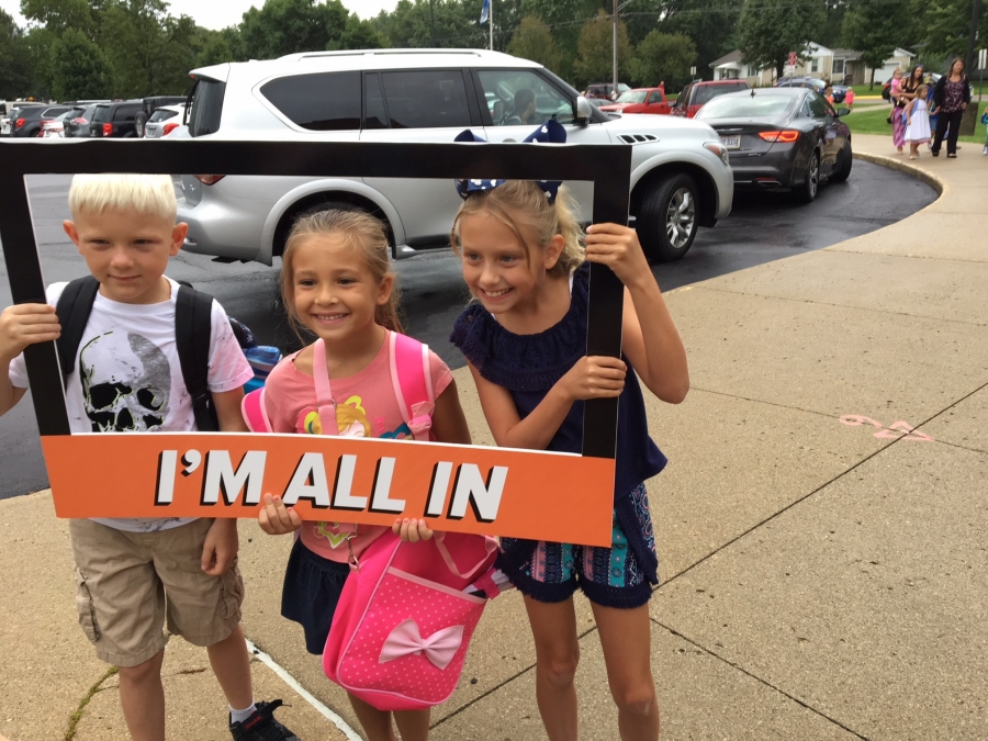 people holding a frame sign